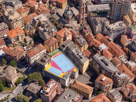 Aerial view of the colorful rooftop basketball court surrounded by historic buildings and the Basilica dei Santi Gervasio e Protasio in Rapallo Liguria Italy. Aerial view of the colorful rooftop basketball court surrounded by historic buildings and the Basilica dei Santi Gervasio e Protasio in Rapallo Liguria Italy.