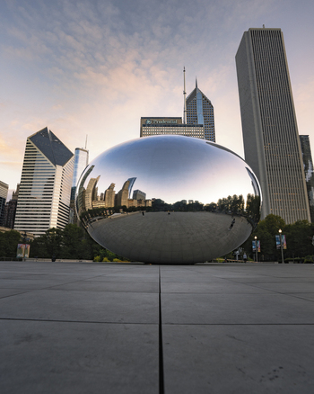 Chicago United States 15 September 2025 View of Cloud Gate sculpture reflecting the surrounding skyscrapers and a soft morning sky in Millennium Park.