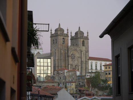 View of the historic Porto Cathedral with its iconic twin towers and rose window rising above the traditional rooftops of the old town in Porto Porto District Portugal. View of the historic Porto Cathedral with its iconic twin towers and rose window rising above the traditional rooftops of the old town in Porto Porto District Portugal.