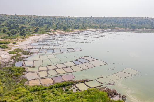Aerial view of Lake Munyanyange salt pans with colorful evaporation ponds and surrounding lush vegetation in Katwe Village Western Region Uganda. Aerial view of Lake Munyanyange salt pans with colorful evaporation ponds and surrounding lush vegetation in Katwe Village Western Region Uganda.