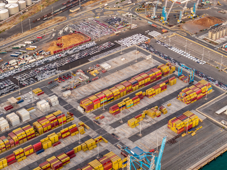 Civitavecchia Italy 22 August 2026 Aerial view of Civitavecchia Port featuring rows of colorful shipping containers parked vehicles and industrial cranes.