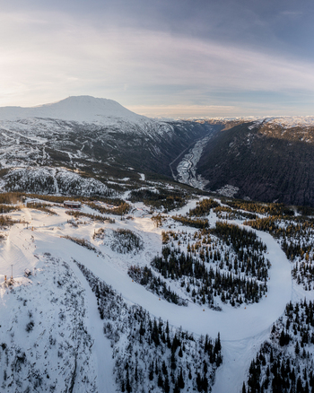 Aerial view of Gaustablikk Fjellresort surrounded by snow covered ski slopes pine forests and mountains in Rjukan Telemark Norway. Aerial view of Gaustablikk Fjellresort surrounded by snow covered ski slopes pine forests and mountains in Rjukan Telemark Norway.