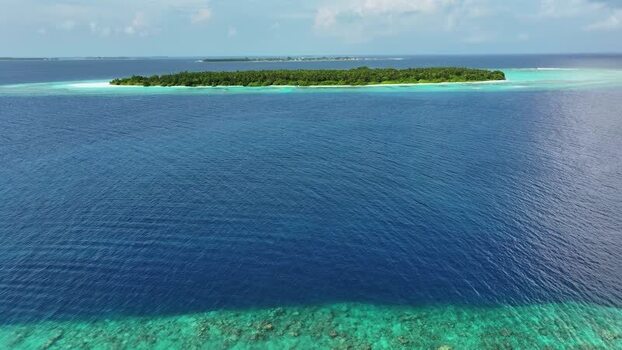 Aerial view of Maalhos island with lush vegetation and coral reefs Maldives. Aerial view of Maalhos island with lush vegetation and coral reefs Maldives.
