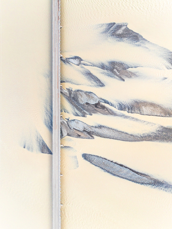 Aerial view of a bridge crossing a braided glacial river with sediment rich water flowing through the landscape in Iceland. Aerial view of a bridge crossing a braided glacial river with sediment rich water flowing through the landscape in Iceland.