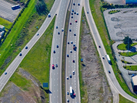 Aerial view of a highway bustling with vehicles cutting through verdant landscapes a dance of steel and nature in harmony Sausheim Grand Est France.