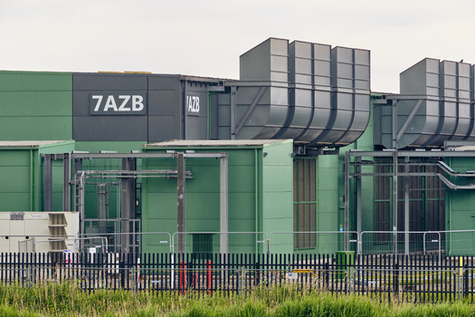 Middenmeer Netherlands 17 May 2026 View of the Microsoft datacenter facility on Agriport featuring large ventilation units industrial green facades and metal fencing.