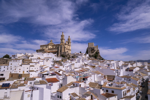 Aerial view of the historic town of Olvera with its iconic white houses the Church of Nuestra Senora de la Encarnacion and the Moorish castle in Olvera Andalusia Spain. Aerial view of the historic town of Olvera with its iconic white houses the Church of Nuestra Senora de la Encarnacion and the Moorish castle in Olvera Andalusia Spain.