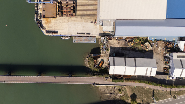 Aerial view of the industrial port area with warehouses a long pier and calm water in Zumaia Basque Country Spain.