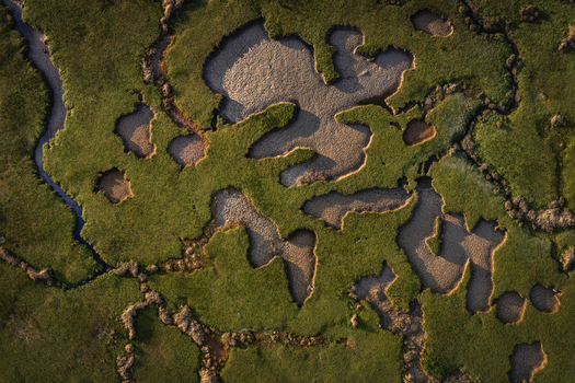 Aerial view of the abstract patterns of salt marshes and sandy patches at Portmarnock Beach in County Dublin Ireland.
