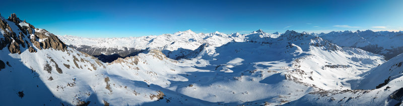 Aerial view of the snow dusted Becs de Bosson peak under a crisp blue sky a panorama of stark beauty and jagged rock formations Anniviers Valais Switzerland. Aerial view of the snow dusted Becs de Bosson peak under a crisp blue sky a panorama of stark beauty and jagged rock formations Anniviers Valais Switzerland.