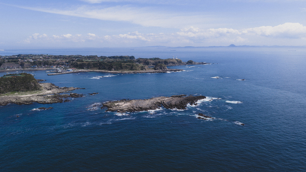 Aerial view of the rugged coastline and rocky islets in the blue sea of Japan. Aerial view of the rugged coastline and rocky islets in the blue sea of Japan.
