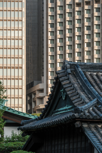 View of a traditional Japanese roof with dark tiles contrasting against modern skyscrapers a blend of old and new architecture Tokyo Tokyo Japan. View of a traditional Japanese roof with dark tiles contrasting against modern skyscrapers a blend of old and new architecture Tokyo Tokyo Japan.