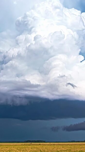 View of massive storm clouds over a golden field Latvia. View of massive storm clouds over a golden field Latvia.