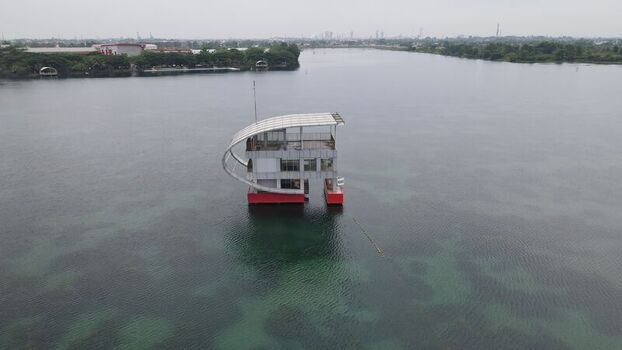 Aerial view of a modern floating structure at Jakabaring Sport City on the lake in Kecamatan Seberang Ulu I Sumatera Selatan Indonesia. Aerial view of a modern floating structure at Jakabaring Sport City on the lake in Kecamatan Seberang Ulu I Sumatera Selatan Indonesia.