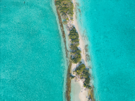 Aerial view of the narrow island with white sand beaches fringed by turquoise waters Dhidhdhoo Thiladhunmathi Atoll Maldives.