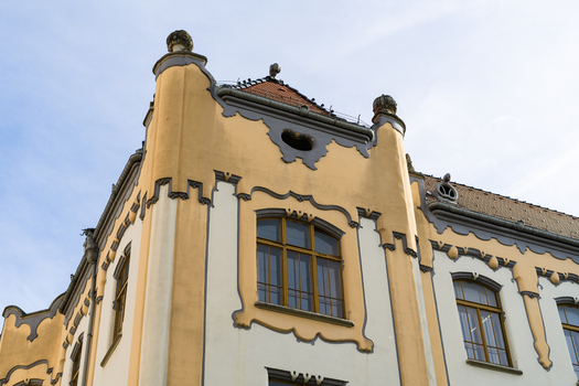 View of the Art Nouveau facade of the Gamca gymnasium with decorative yellow walls and grey ornaments under a clear sky in Bratislava Bratislava Region Slovakia. View of the Art Nouveau facade of the Gamca gymnasium with decorative yellow walls and grey ornaments under a clear sky in Bratislava Bratislava Region Slovakia.