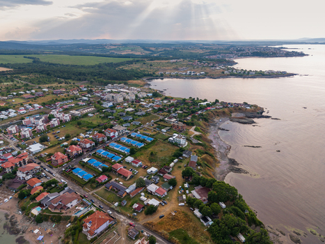 Aerial view of the coastal area of Arapya with houses green fields and the sea under soft sunlight in Burgas Bulgaria. Aerial view of the coastal area of Arapya with houses green fields and the sea under soft sunlight in Burgas Bulgaria.