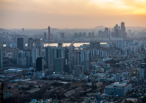 Aerial view of the dense urban skyline featuring modern skyscrapers residential apartment complexes and a river flowing through the city in Busan Busan South Korea. Aerial view of the dense urban skyline featuring modern skyscrapers residential apartment complexes and a river flowing through the city in Busan Busan South Korea.