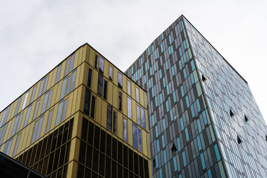 View of modern skyscrapers with yellow and blue glass facades under an overcast sky in Vienna Vienna Austria. View of modern skyscrapers with yellow and blue glass facades under an overcast sky in Vienna Vienna Austria.