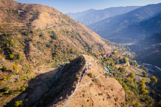 Aerial view of Chakrata hill station featuring winding mountain roads and rugged terrain under a clear blue sky in Chakrata Uttarakhand India. Aerial view of Chakrata hill station featuring winding mountain roads and rugged terrain under a clear blue sky in Chakrata Uttarakhand India.