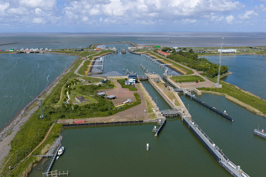 Aerial view of the Lorentzsluizen lock complex with water channels and green embankments on the Afsluitdijk in Kornwerderzand Friesland Netherlands.