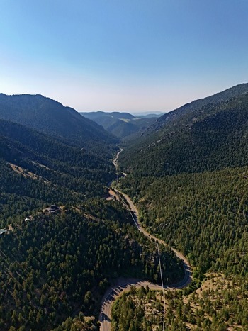 Aerial view of the winding road through the forested Coal Creek valley in the mountains of Coal Creek Colorado United States. Aerial view of the winding road through the forested Coal Creek valley in the mountains of Coal Creek Colorado United States.