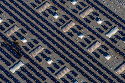 Aerial view of solar panels installed on a large industrial roof with skylights in Nera Montoro Umbria Italy. Aerial view of solar panels installed on a large industrial roof with skylights in Nera Montoro Umbria Italy.