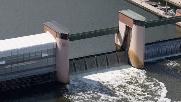 Aerial view of Neckar Staustufe und Schleuse Rockenau with water flowing over the weir and scaffolding on the concrete structure in Eberbach Baden Wurttemberg Germany. Aerial view of Neckar Staustufe und Schleuse Rockenau with water flowing over the weir and scaffolding on the concrete structure in Eberbach Baden Wurttemberg Germany.