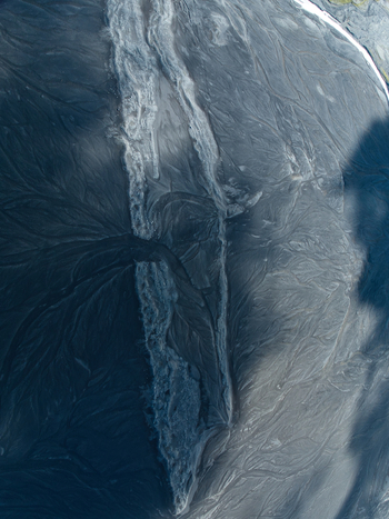 Aerial view of the intricate braided river patterns and dark volcanic sand deposits of the glacial landscape near Maelifell Kirkjubaejarklaustur Skaftarhreppur Iceland. Aerial view of the intricate braided river patterns and dark volcanic sand deposits of the glacial landscape near Maelifell Kirkjubaejarklaustur Skaftarhreppur Iceland.