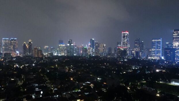 Aerial view of the illuminated skyline featuring modern skyscrapers office buildings and residential areas in South Jakarta Jakarta Indonesia. Aerial view of the illuminated skyline featuring modern skyscrapers office buildings and residential areas in South Jakarta Jakarta Indonesia.