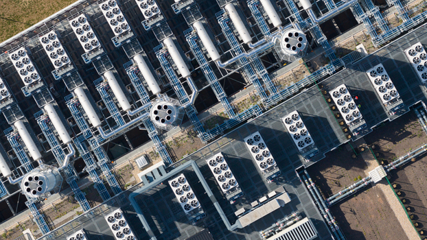 Aerial view of industrial HVAC units and cooling fans arranged on a large facility roof with complex pipe networks in Dietzenbach Hessen Germany. Aerial view of industrial HVAC units and cooling fans arranged on a large facility roof with complex pipe networks in Dietzenbach Hessen Germany.