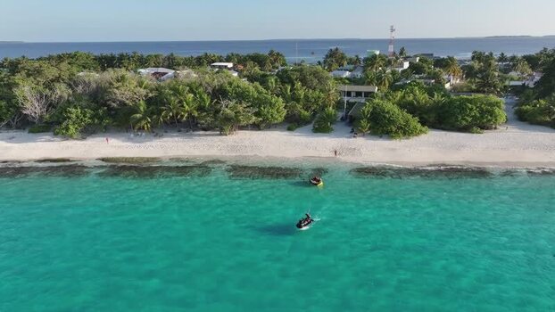 Aerial view of tropical island beach and turquoise water Maldives. Aerial view of tropical island beach and turquoise water Maldives.