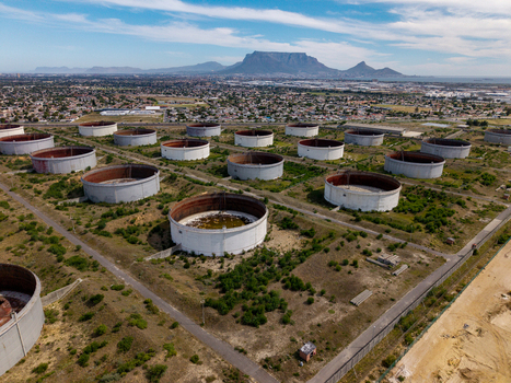 Aerial view of industrial oil storage tanks in Milnerton with Table Mountain in the background in Cape Town Western Cape South Africa. Aerial view of industrial oil storage tanks in Milnerton with Table Mountain in the background in Cape Town Western Cape South Africa.
