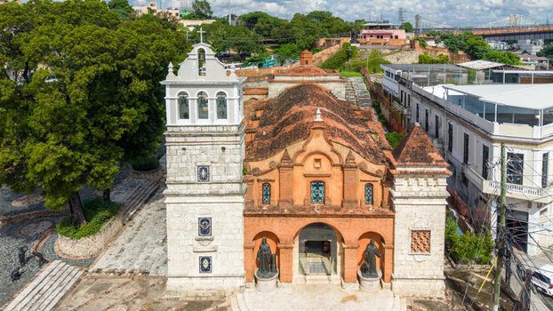 Aerial view of the historic Catedral Castrense de Santa Barbara with its orange facade and white bell tower in Santo Domingo Distrito Nacional Dominican Republic. Aerial view of the historic Catedral Castrense de Santa Barbara with its orange facade and white bell tower in Santo Domingo Distrito Nacional Dominican Republic.