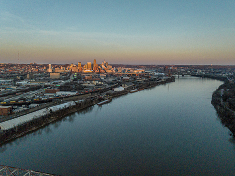 Aerial view of the Missouri River reflecting the warm glow of the setting sun against the backdrop of the city skyline Kansas City Missouri United States. Aerial view of the Missouri River reflecting the warm glow of the setting sun against the backdrop of the city skyline Kansas City Missouri United States.