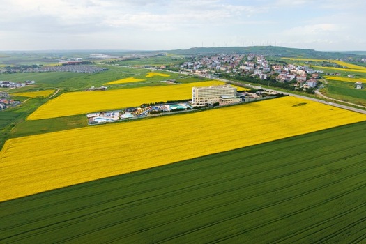 Aerial view of a large hotel complex with a waterpark surrounded by bright yellow canola and green fields Silivri Istanbul Turkey. Aerial view of a large hotel complex with a waterpark surrounded by bright yellow canola and green fields Silivri Istanbul Turkey.