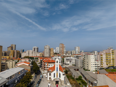 Aerial view of Igreja de Nossa Senhora do Desterro surrounded by urban buildings and rooftops in the city of Povoa de Varzim Porto Portugal. Aerial view of Igreja de Nossa Senhora do Desterro surrounded by urban buildings and rooftops in the city of Povoa de Varzim Porto Portugal.