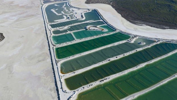 Aerial view of salt production ponds with vibrant green and turquoise water patterns surrounded by white salt flats in Kalbarri Western Australia Australia. Aerial view of salt production ponds with vibrant green and turquoise water patterns surrounded by white salt flats in Kalbarri Western Australia Australia.