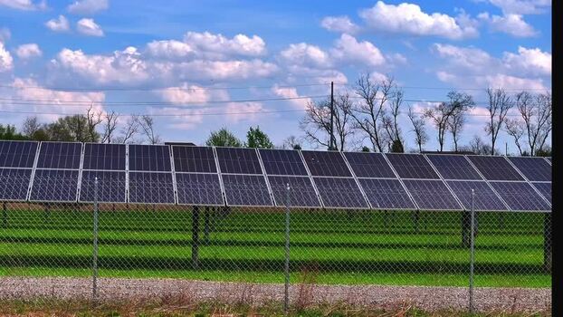 Aerial view of solar panels in a field under a cloudy sky United States. Aerial view of solar panels in a field under a cloudy sky United States.