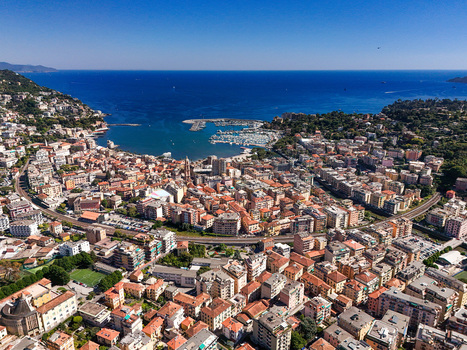Aerial view of the coastal town of Rapallo featuring the harbor with boats colorful buildings and the blue sea under a clear sky Rapallo Liguria Italy. Aerial view of the coastal town of Rapallo featuring the harbor with boats colorful buildings and the blue sea under a clear sky Rapallo Liguria Italy.