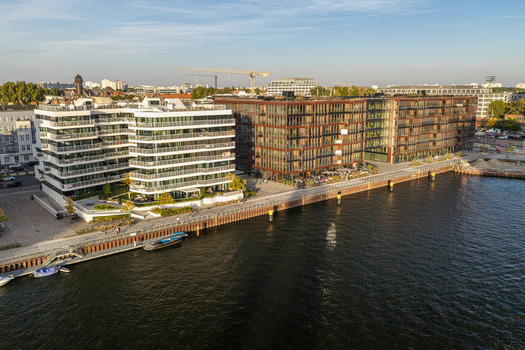 Aerial view of Spreespeicher Promenade along the Spree river featuring modern office buildings and residential architecture with glass facades and balconies in Berlin Berlin Germany. Aerial view of Spreespeicher Promenade along the Spree river featuring modern office buildings and residential architecture with glass facades and balconies in Berlin Berlin Germany.
