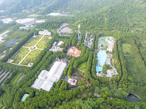 Aerial view of Formosan Aboriginal Culture Village featuring amusement park rides lush green forests manicured gardens and water attractions in Yuchi Township Nantou County Taiwan. Aerial view of Formosan Aboriginal Culture Village featuring amusement park rides lush green forests manicured gardens and water attractions in Yuchi Township Nantou County Taiwan.