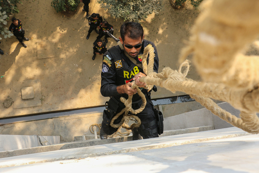 Dhaka Bangladesh 08 January 2017 View of a Rapid Action Battalion officer rappelling down a building wall during a training exercise at the RAB Headquarters. Dhaka Bangladesh 08 January 2017 View of a Rapid Action Battalion officer rappelling down a building wall during a training exercise at the RAB Headquarters.