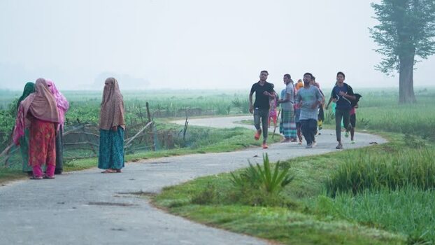 View of people jogging on a rural road in Bogura Bangladesh.