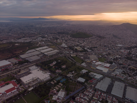 Aerial view of industrial warehouses and urban sprawl at sunset in Tlaquepaque Jalisco Mexico. Aerial view of industrial warehouses and urban sprawl at sunset in Tlaquepaque Jalisco Mexico.