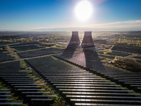 Trino Italy 30 March 2026 Aerial view of a vast solar farm casting long shadows from cooling towers a stark contrast against the bright sun and clear blue sky. Trino Italy 30 March 2026 Aerial view of a vast solar farm casting long shadows from cooling towers a stark contrast against the bright sun and clear blue sky.