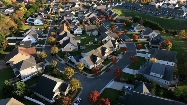 Aerial view of a suburban residential neighborhood with houses winding streets and colorful autumn trees in Lynchburg Virginia United States.