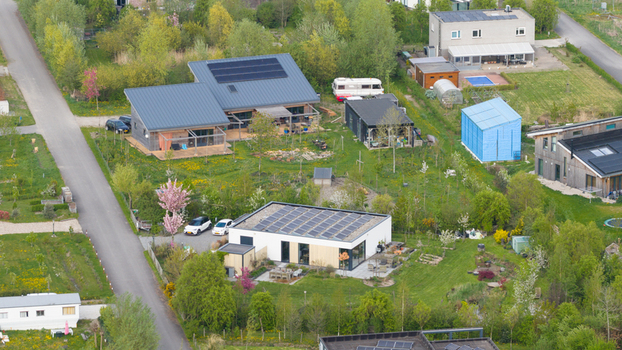 Aerial view of the sustainable houses at Ecodorp Bolderburen featuring solar panels and lush gardens in Almere Flevoland Netherlands. Aerial view of the sustainable houses at Ecodorp Bolderburen featuring solar panels and lush gardens in Almere Flevoland Netherlands.