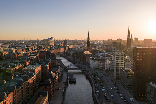 Aerial view of the historic Speicherstadt warehouse district Elbphilharmonie concert hall and city canals under a warm sunset sky in Hamburg Hamburg Germany. Aerial view of the historic Speicherstadt warehouse district Elbphilharmonie concert hall and city canals under a warm sunset sky in Hamburg Hamburg Germany.