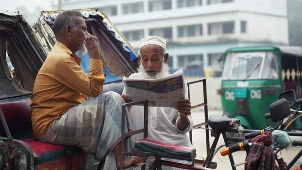 View of two elderly men sitting on a rickshaw in Bogura Bangladesh. View of two elderly men sitting on a rickshaw in Bogura Bangladesh.